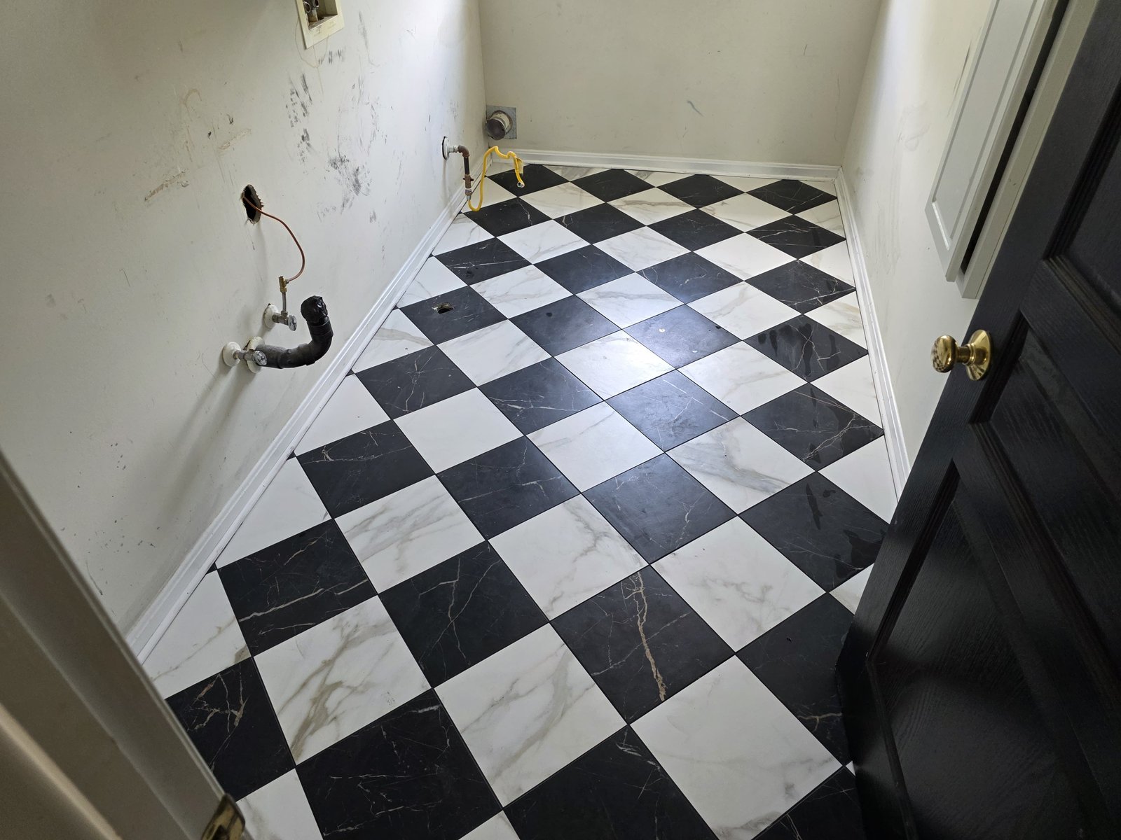 Checkerboard porcelain tile laundry floor