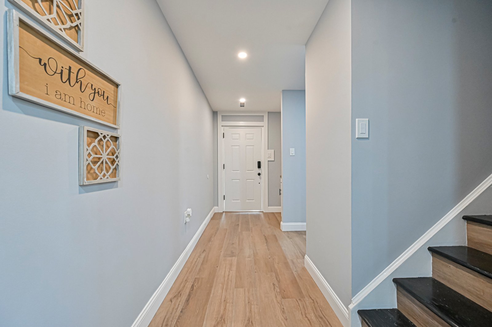 Entry hallway with LVP flooring and stair treads