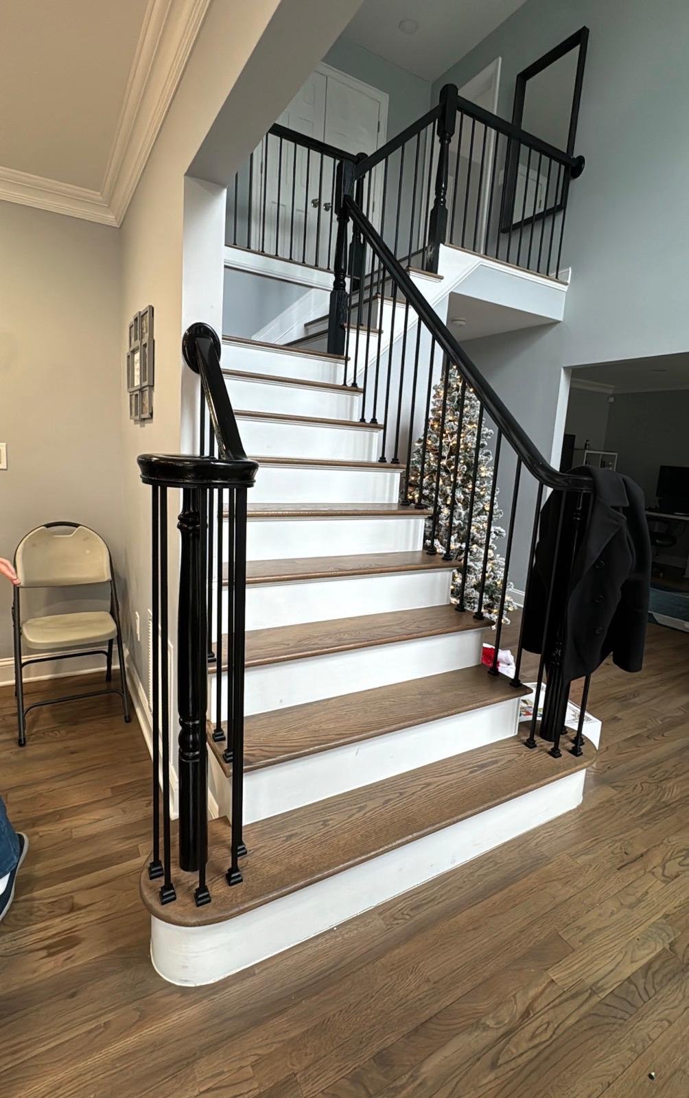 Oak treads with dark handrail and iron balusters